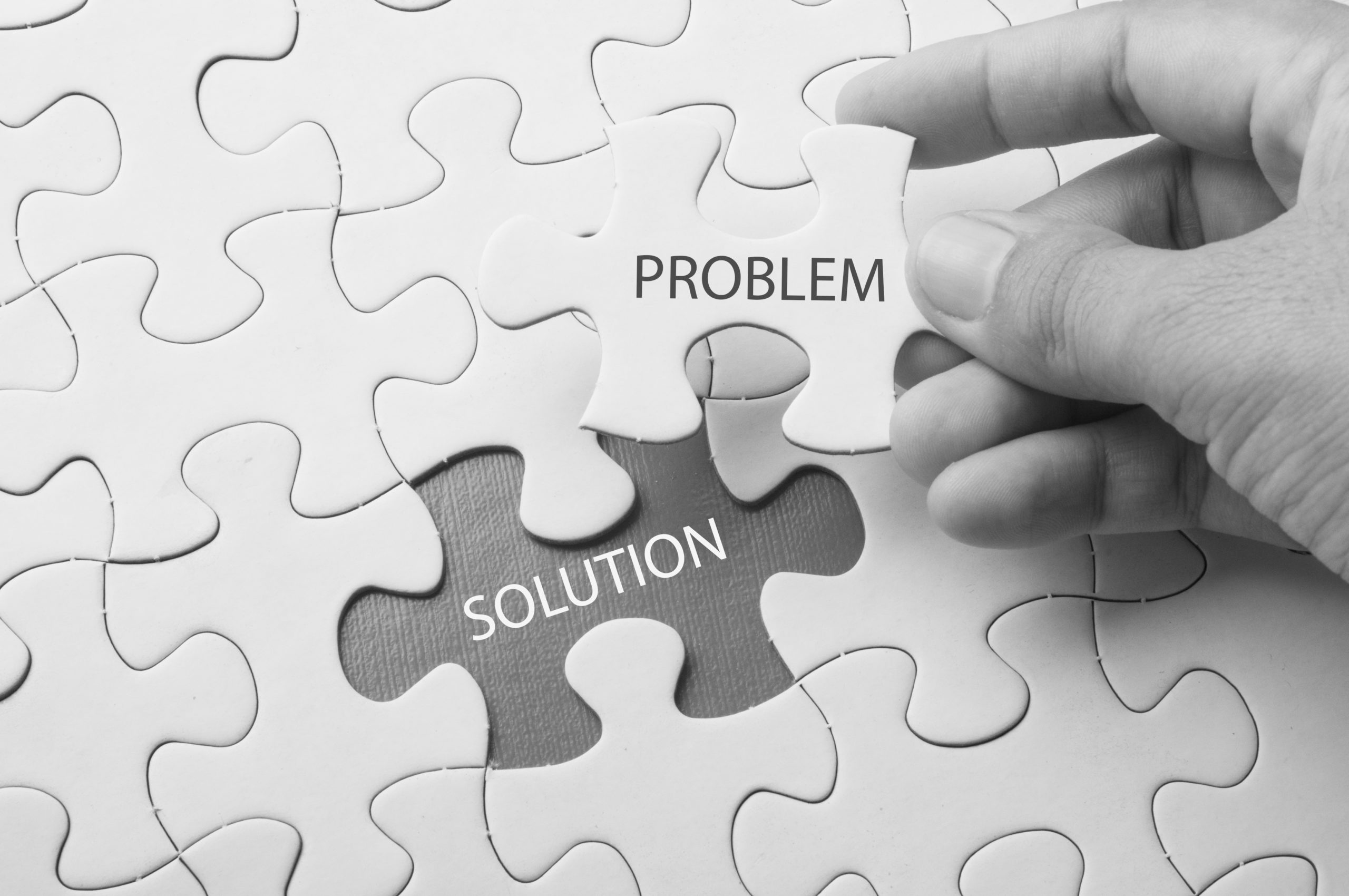 Puzzle pieces that read “solution” and “problem”