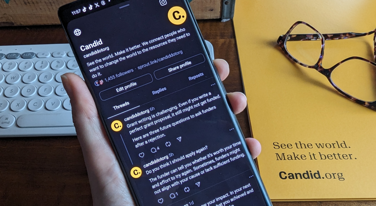 Someone looking at Candid's social media account on their phone.