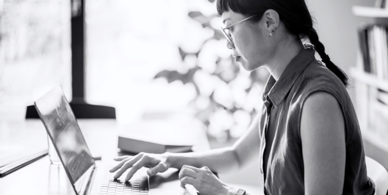 A woman doing research on her laptop.